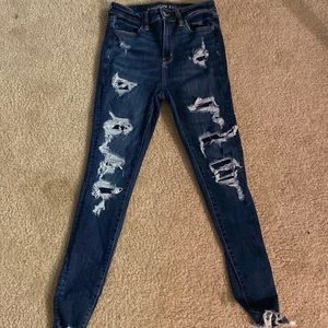 American eagle covered rips , size 4 next level stretch. dark blue .